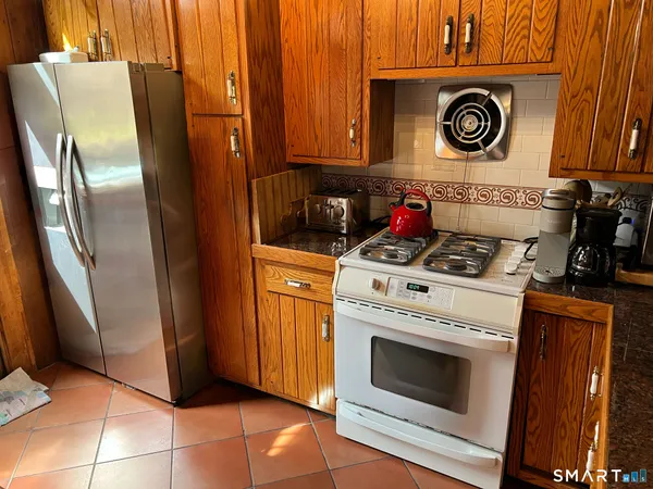 a stove top oven sitting inside of a kitchen