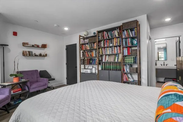 a bedroom with a bed and a book shelf