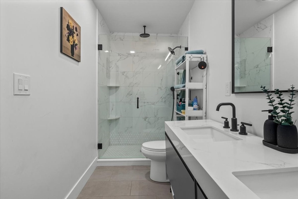 173 Magnolia Street, Unit 5 Boston, MA 02125 - Photo 13 of 23 a bathroom with a sink a toilet and shower