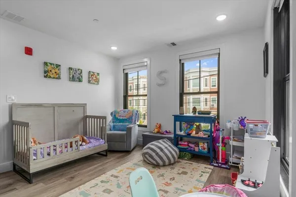 a bedroom with furniture and a wooden floor