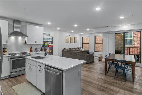 a kitchen with a stove a sink and a refrigerator