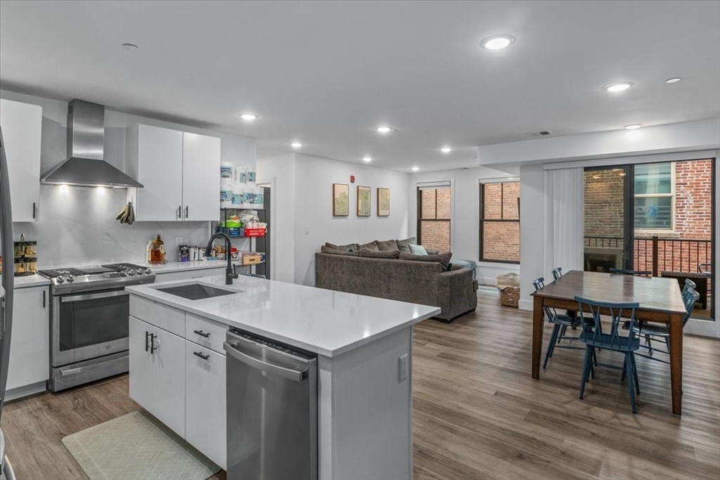 173 Magnolia Street, Unit 5 Boston, MA 02125 - Photo 4 of 23 a kitchen with a stove a sink and a refrigerator