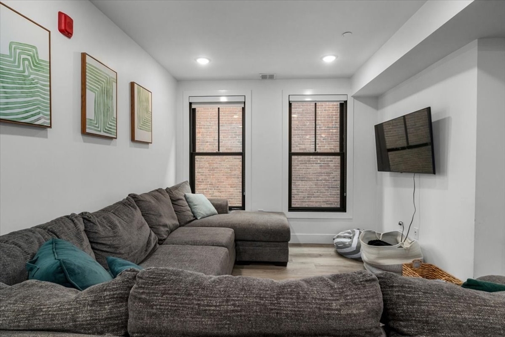 173 Magnolia Street, Unit 5 Boston, MA 02125 - Photo 7 of 23 a living room with furniture and a flat screen tv