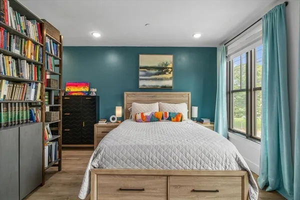 a bedroom with a bed and a bookshelf