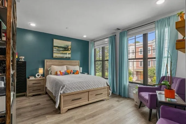 a bedroom with a large bed and a window