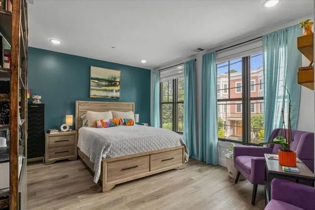 a bedroom with a large bed and a window