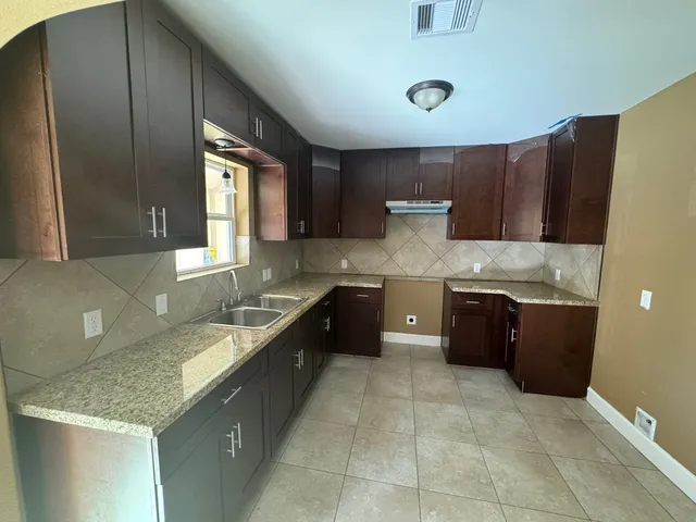 a kitchen with a stove a sink and a refrigerator
