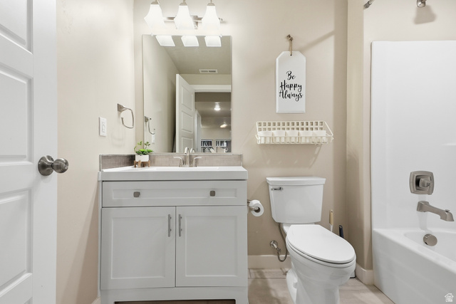 3244 West 1670th Street North Provo, UT 84601 - Photo 46 of 56 Bathroom featuring a white vanity with a light-colored countertop, an undermount sink with a brushed nickel faucet, a mirror with a three-light fixture, a toilet, and a white bathtub with brushed nickel fixtures