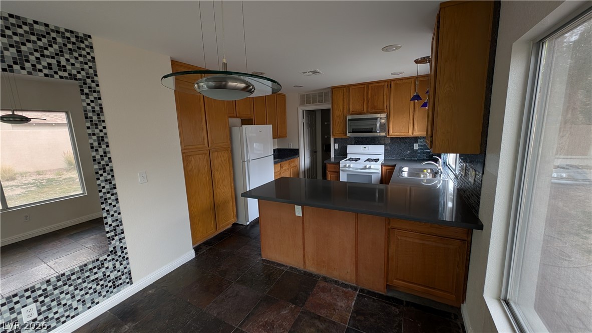 2670 Ridgewater Circle Henderson, NV 89074 - Photo 7 of 22 This bright kitchen features ample counter space, modern appliances, and a convenient layout perfect for entertaining.