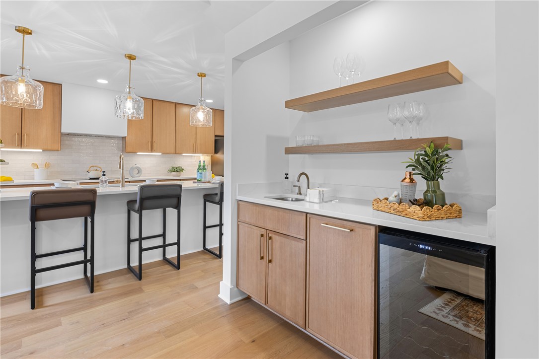 117 Riverpoint Drive Clemson, SC 29631 - Photo 12 of 47 This modern kitchen and adjacent wet bar offer sleek design and practical living spaces.