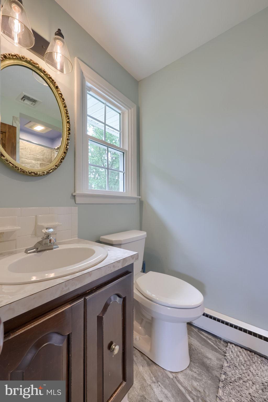 1019 Devonshire Road Lancaster, PA 17601 - Photo 21 of 35 a bathroom with a sink a toilet and a mirror