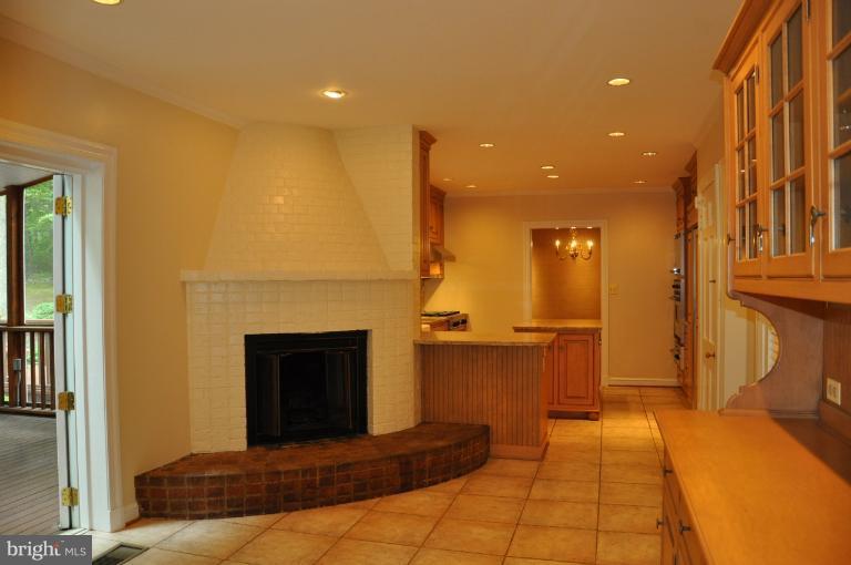5816 Marbury Road Bethesda, MD 20817 - Photo 5 of 18 a living room with a couch and a fireplace