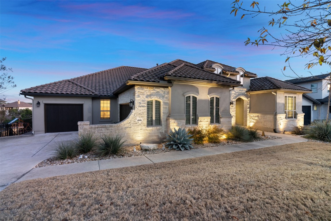 304 Tempranillo Way Austin, TX 78738 - Photo 1 of 40 a front view of a house with a yard