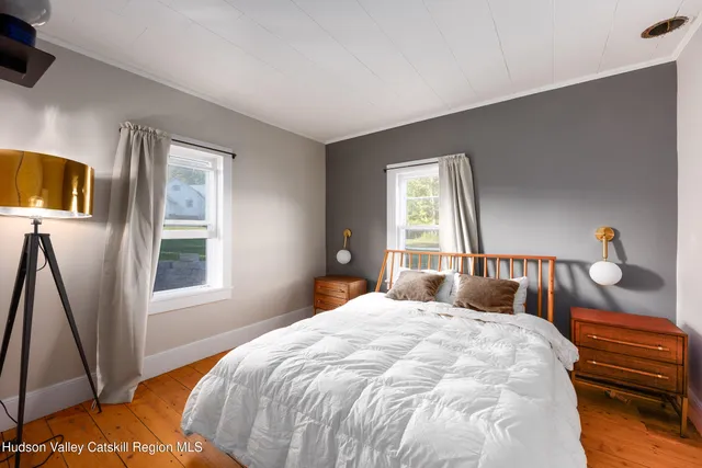 a bedroom with a bed next to a window with outer view