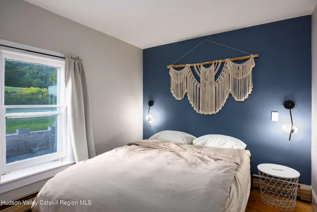 a bedroom with a bed and glass window