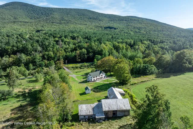 an aerial view of a house with a yard