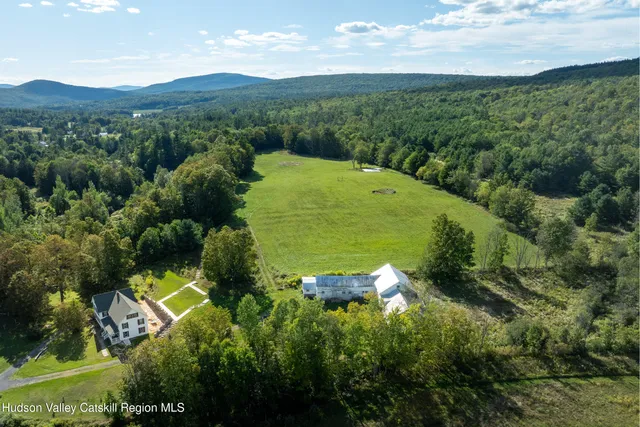 an aerial view of a house with a garden and trees