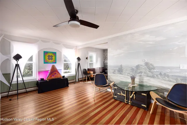 a living room with furniture and wooden floor