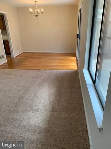 a kitchen with a stove a sink a refrigerator and wooden floor