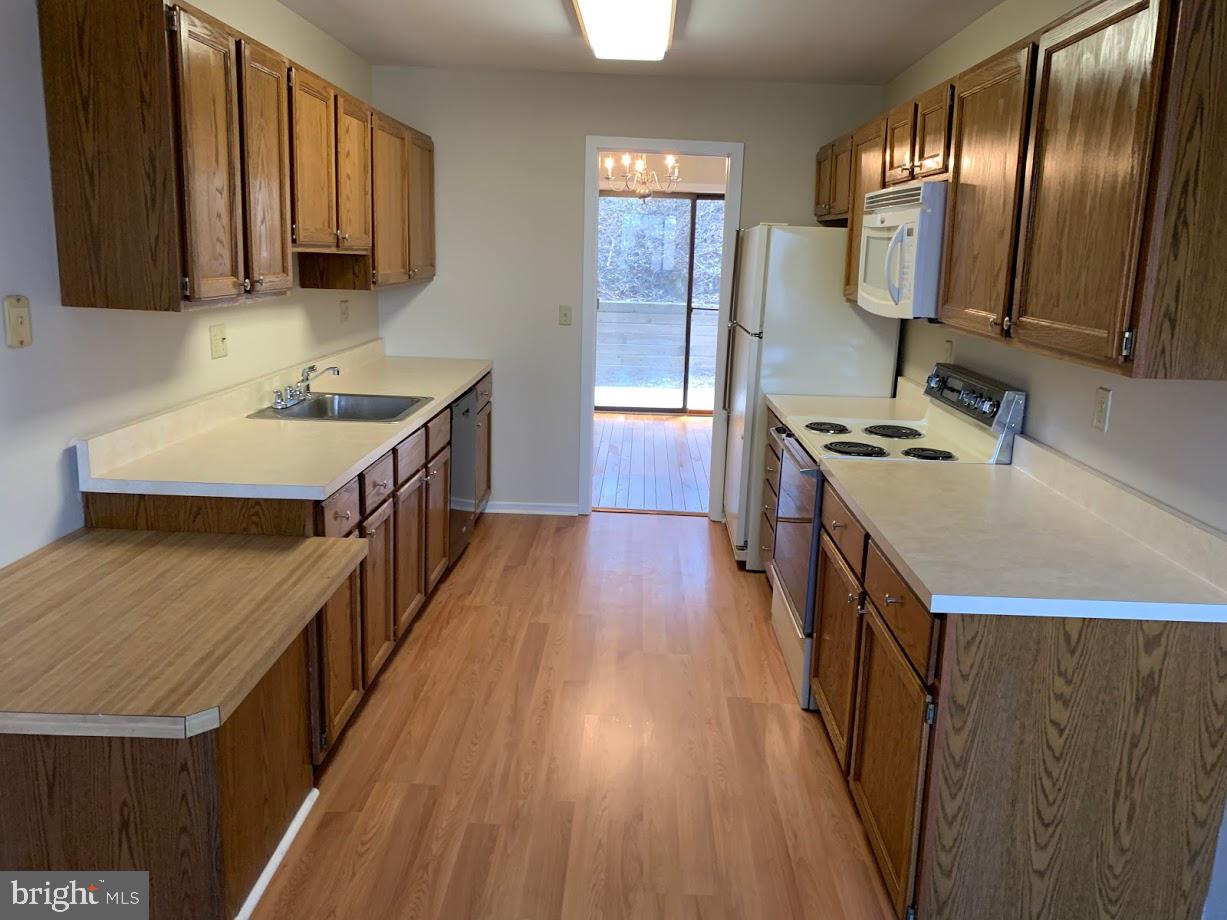 468 Lynetree Drive West Chester, PA 19380 - Photo 15 of 43 a kitchen with a stove a sink a refrigerator and wooden floor