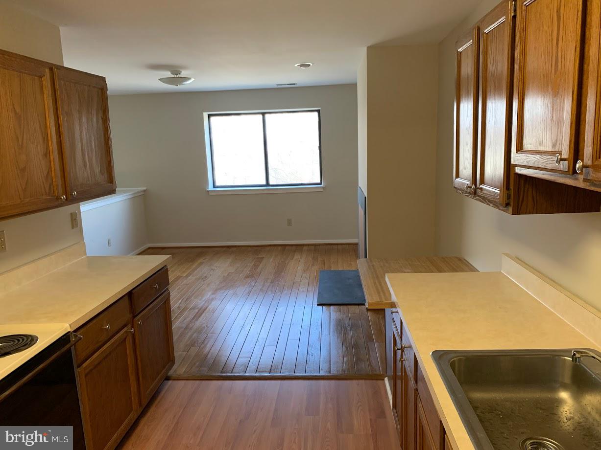 468 Lynetree Drive West Chester, PA 19380 - Photo 16 of 43 a view of a kitchen with wooden floor and staircase