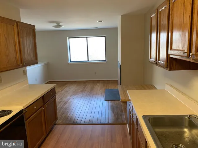 a kitchen with wooden floors and appliances