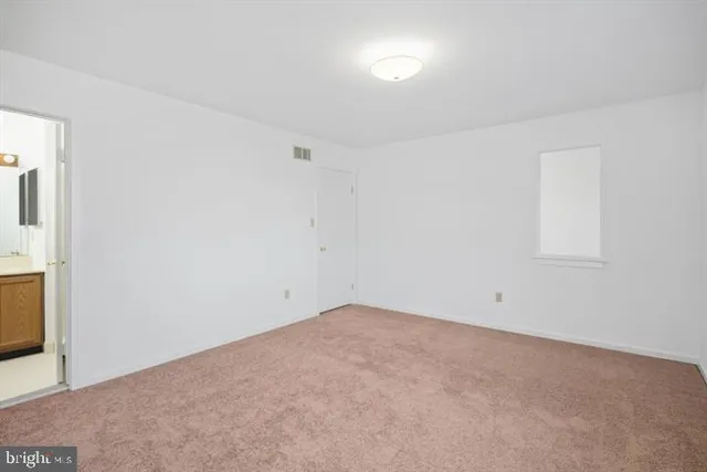 an empty room with a empty space and windows