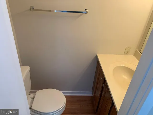 a white toilet sitting next to a small sink