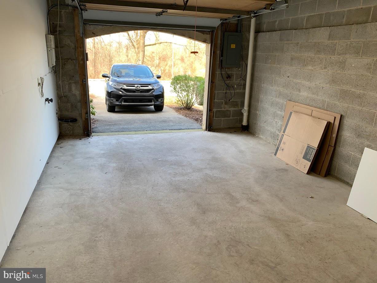 468 Lynetree Drive West Chester, PA 19380 - Photo 43 of 43 a living room with a fireplace and a floor to ceiling window