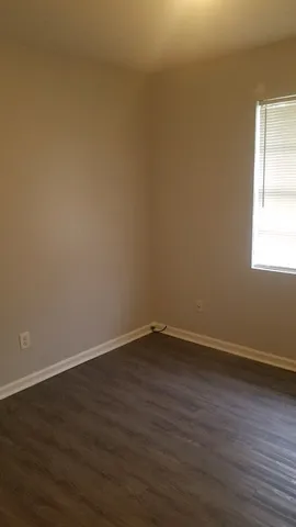 a view of a room with wooden floor