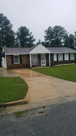a front view of a house with a garden