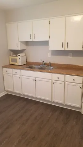 a stove top oven sitting inside of a kitchen