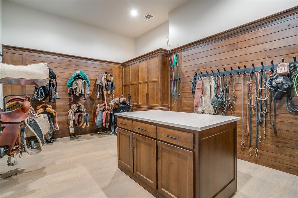 5000 T W King Road Southlake, TX 76092 - Photo 13 of 40 Custom barn interior showing climate-controlled tack room and equine medical suite.