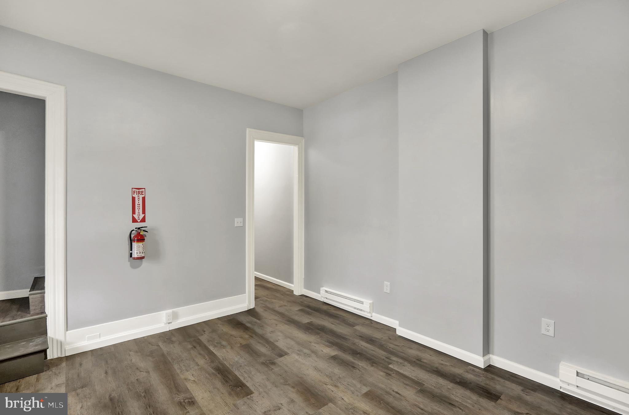 1156 Franklin Street, Unit 3 Reading, PA 19602 - Photo 3 of 11 an empty room with wooden floor and windows