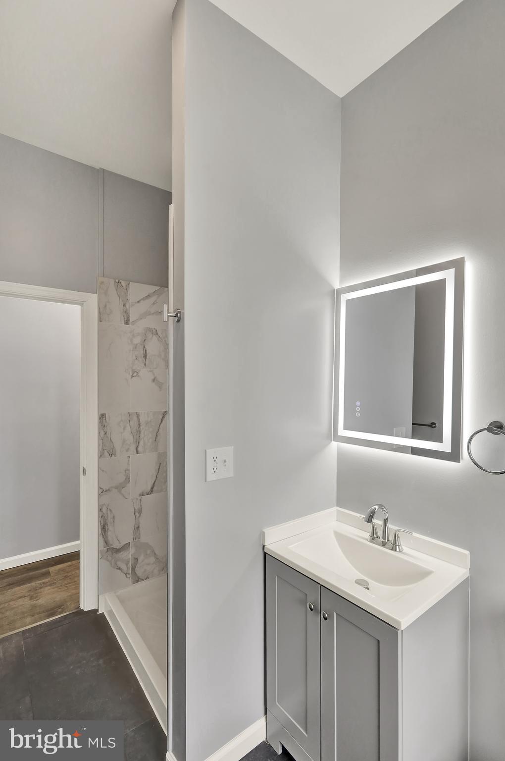 1156 Franklin Street, Unit 3 Reading, PA 19602 - Photo 5 of 11 a bathroom with a sink a mirror and a shower