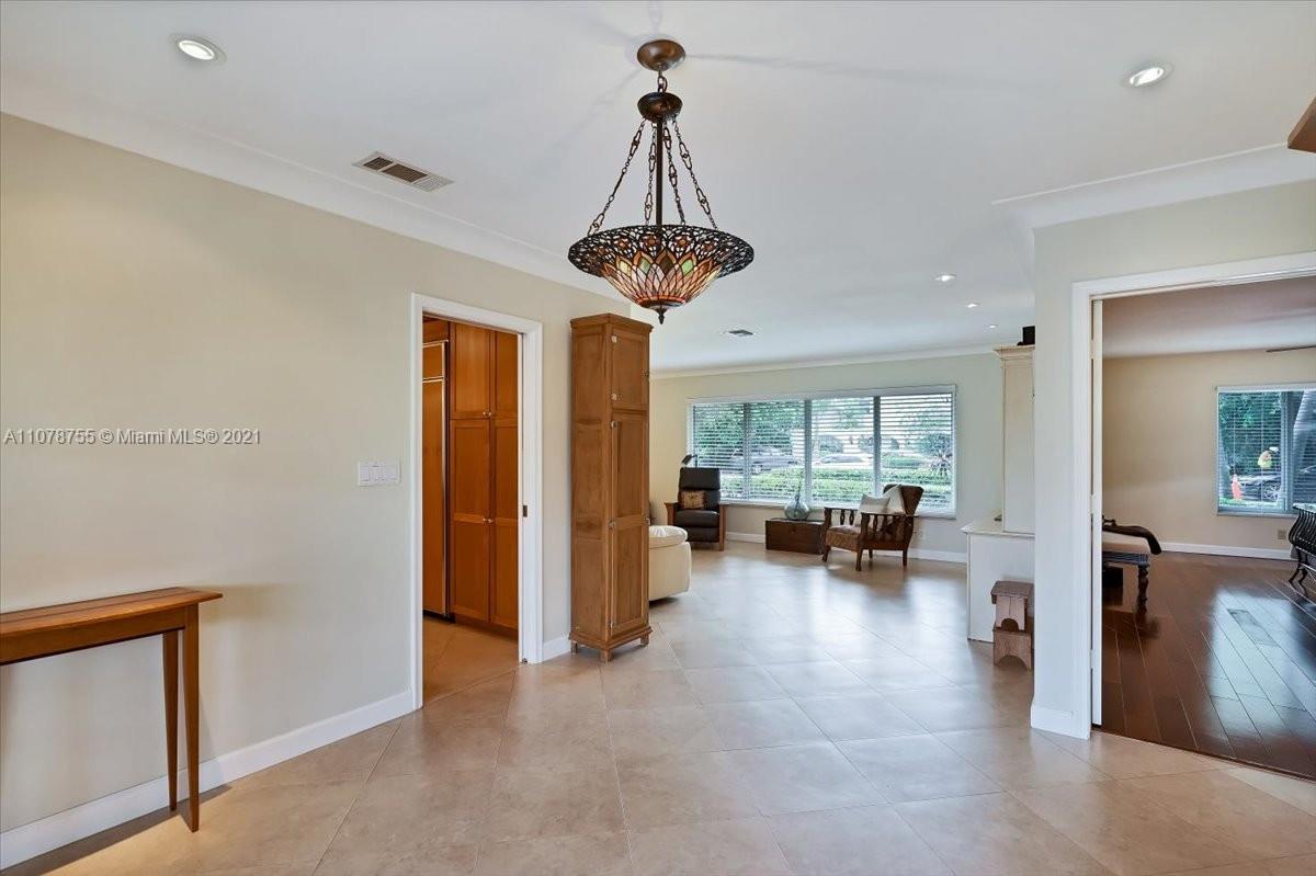 1525 Southwest 6th Avenue Boca Raton, FL 33486 - Photo 12 of 30 a living room with furniture and a chandelier