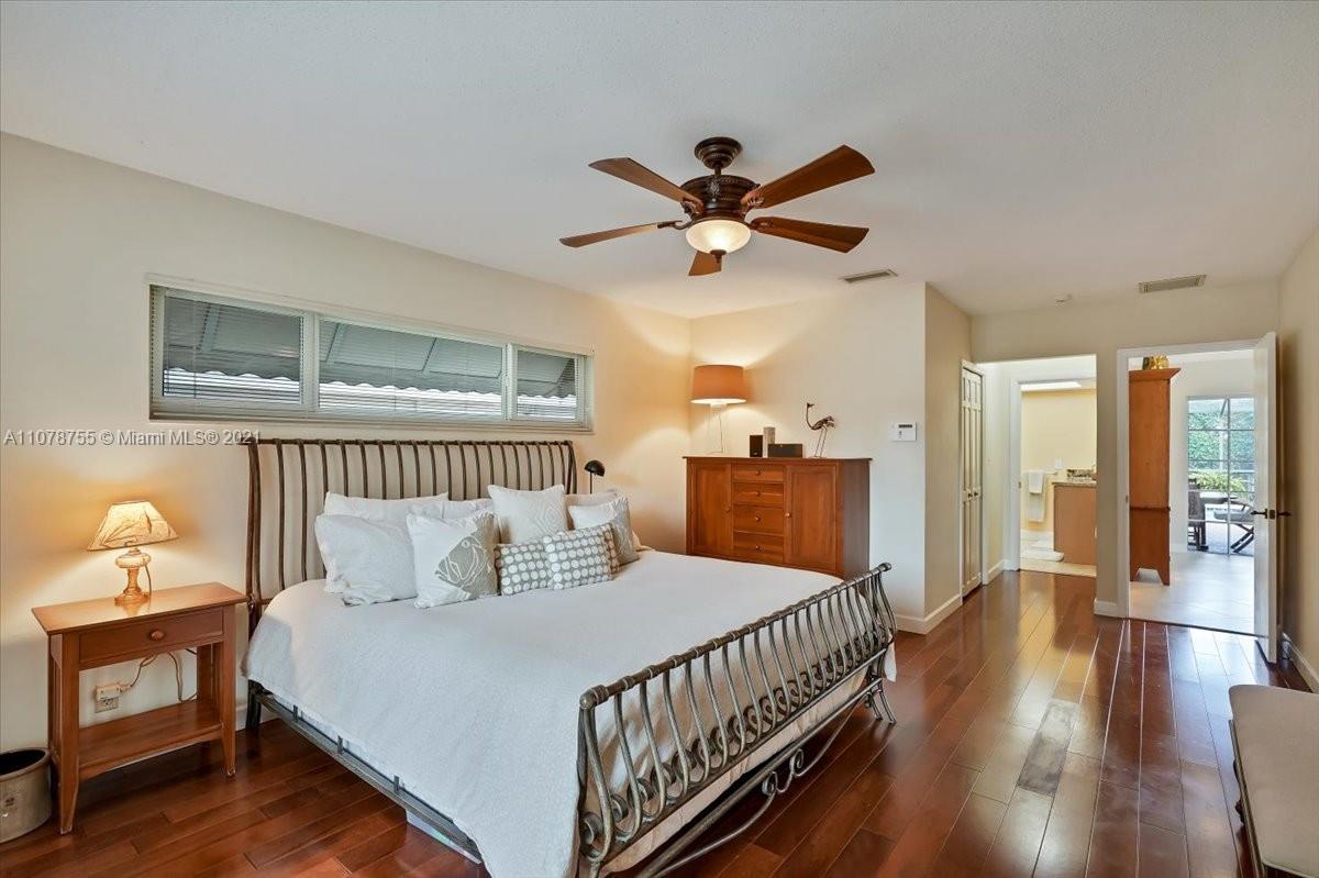 1525 Southwest 6th Avenue Boca Raton, FL 33486 - Photo 17 of 30 a bedroom with a bed and wooden floor