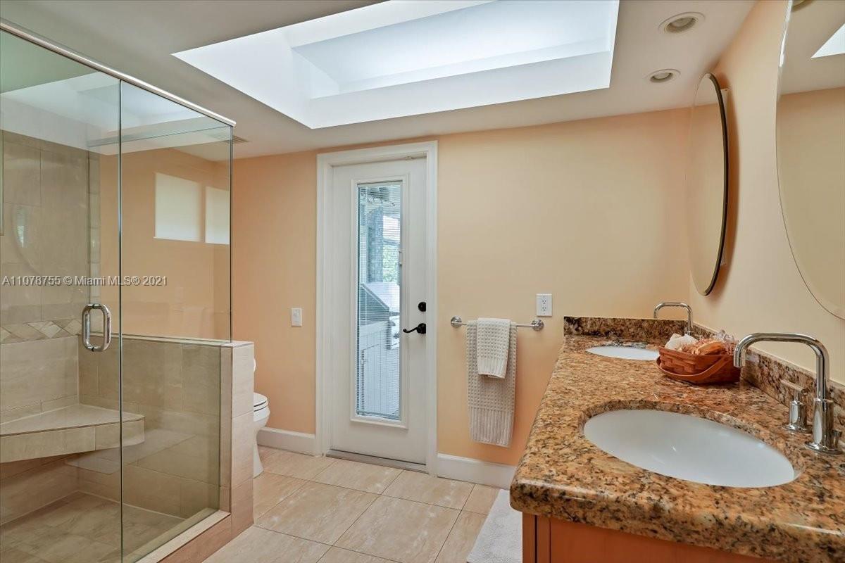 1525 Southwest 6th Avenue Boca Raton, FL 33486 - Photo 18 of 30 a bathroom with a granite countertop sink and a mirror