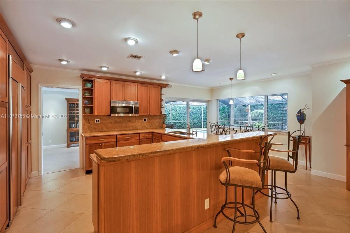 1525 Southwest 6th Avenue Boca Raton, FL 33486 - Photo 6 of 30 a open kitchen with stainless steel appliances granite countertop a stove and a refrigerator
