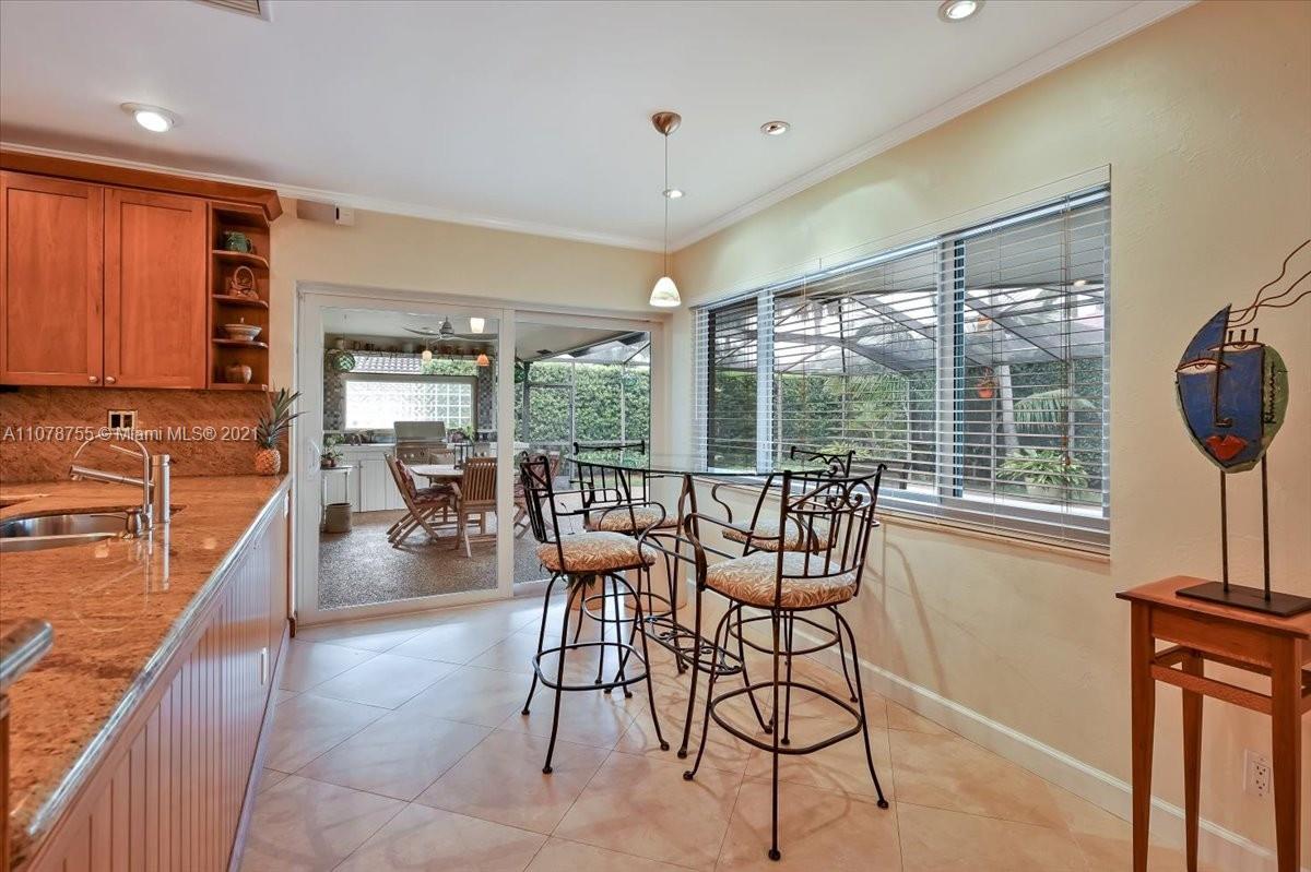 1525 Southwest 6th Avenue Boca Raton, FL 33486 - Photo 7 of 30 a dining room with furniture a chandelier and wooden floor