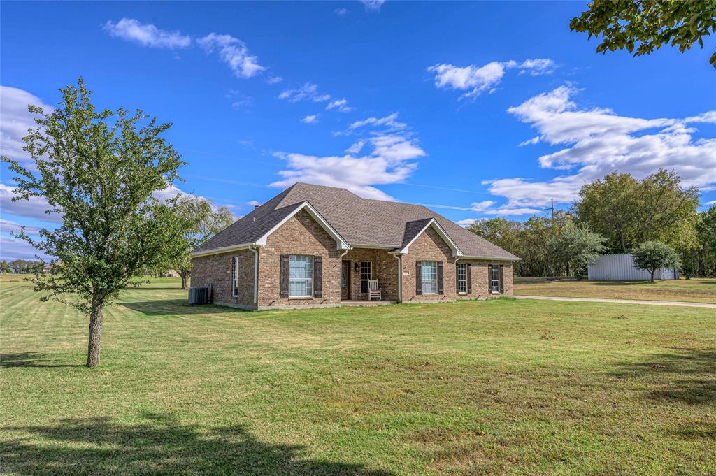 10264 Farmington Road Van Alstyne, TX 75495 - Photo 6 of 39 a view of a house with a yard
