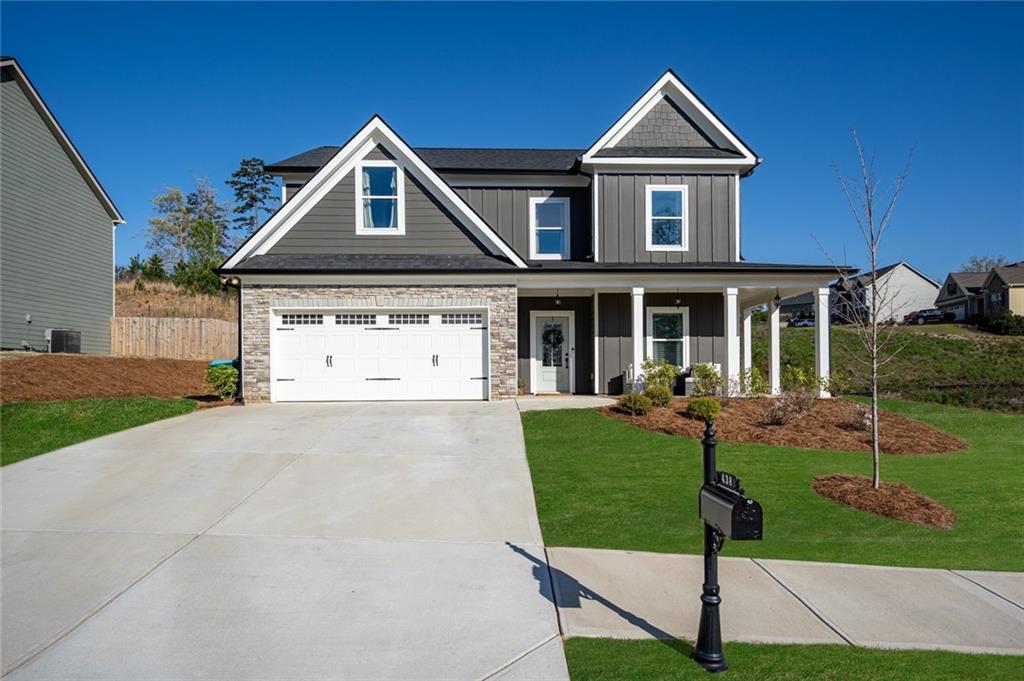 438 Tom Avery Drive Ball Ground, GA 30107 - Photo 1 of 1 a front view of a house with garden