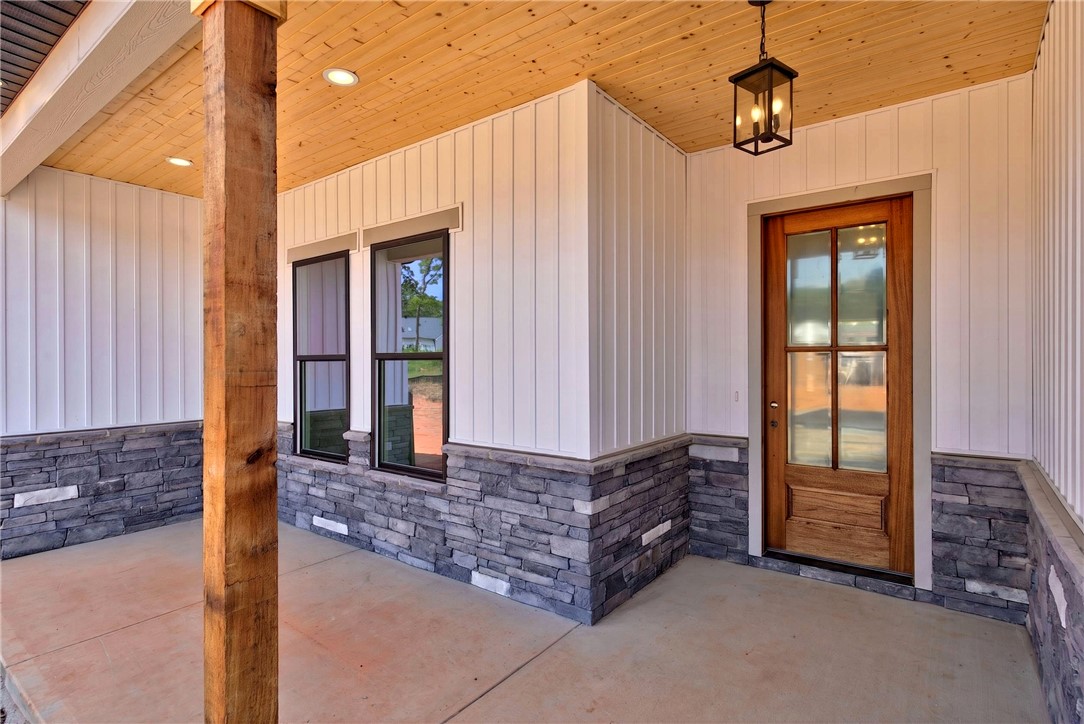 424 Blume Road Anderson, SC 29625 - Photo 4 of 30 A welcoming entry featuring rich wood door, natural wood ceiling, and stone accents.