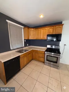 a kitchen with stainless steel appliances a sink and a stove
