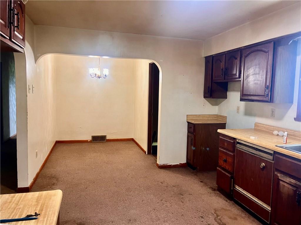 946 Herman Butler, PA 16002 - Photo 12 of 20 a view of a kitchen with fridge and wooden floor