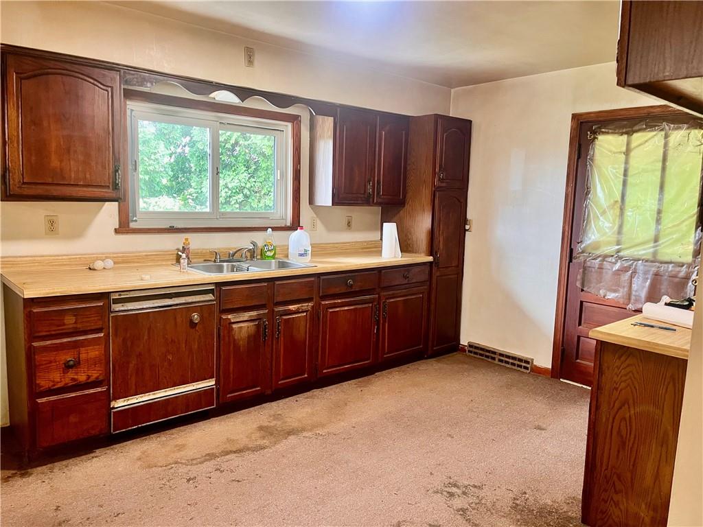 946 Herman Butler, PA 16002 - Photo 10 of 20 a kitchen with stainless steel appliances granite countertop a stove a sink dishwasher and wooden cabinets
