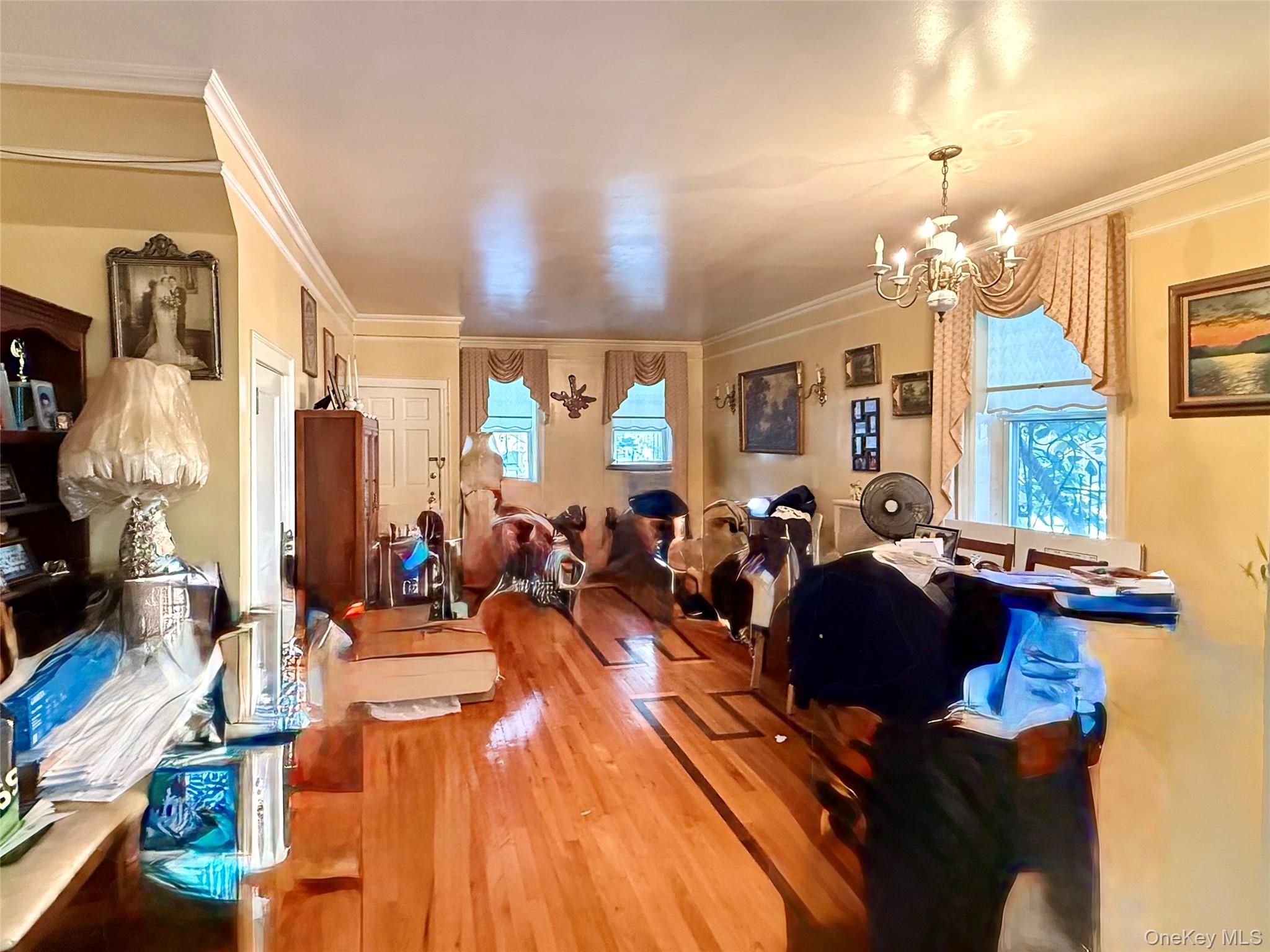 19-01 21st Road Queens, NY 11105 - Photo 4 of 8 a living room with lots of furniture and a chandelier