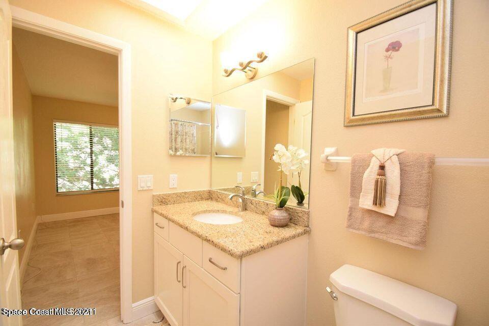 670 Cedar Side Circle Northeast Palm Bay, FL 32905 - Photo 15 of 22 a bathroom with a sink and a mirror