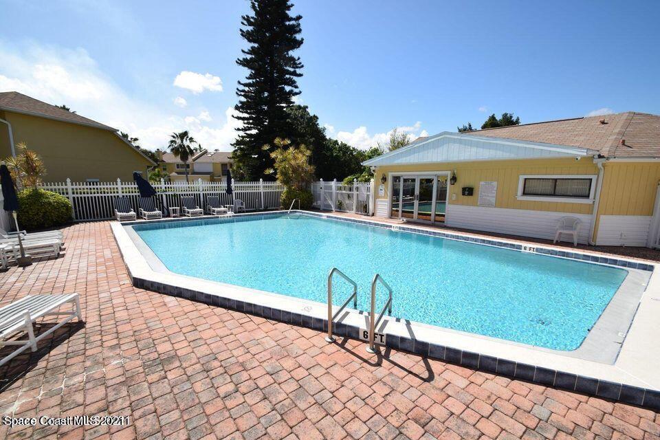 670 Cedar Side Circle Northeast Palm Bay, FL 32905 - Photo 22 of 22 a view of a swimming pool with a lounge chairs