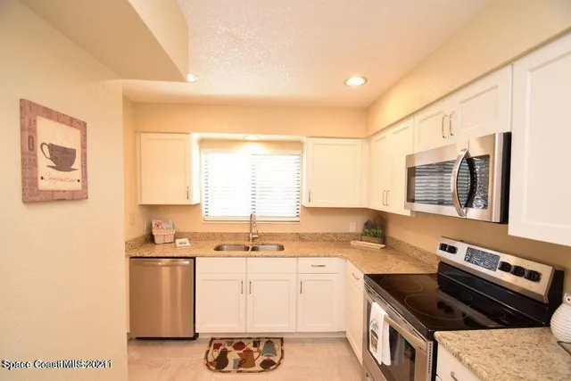 a kitchen that has a sink and a stove